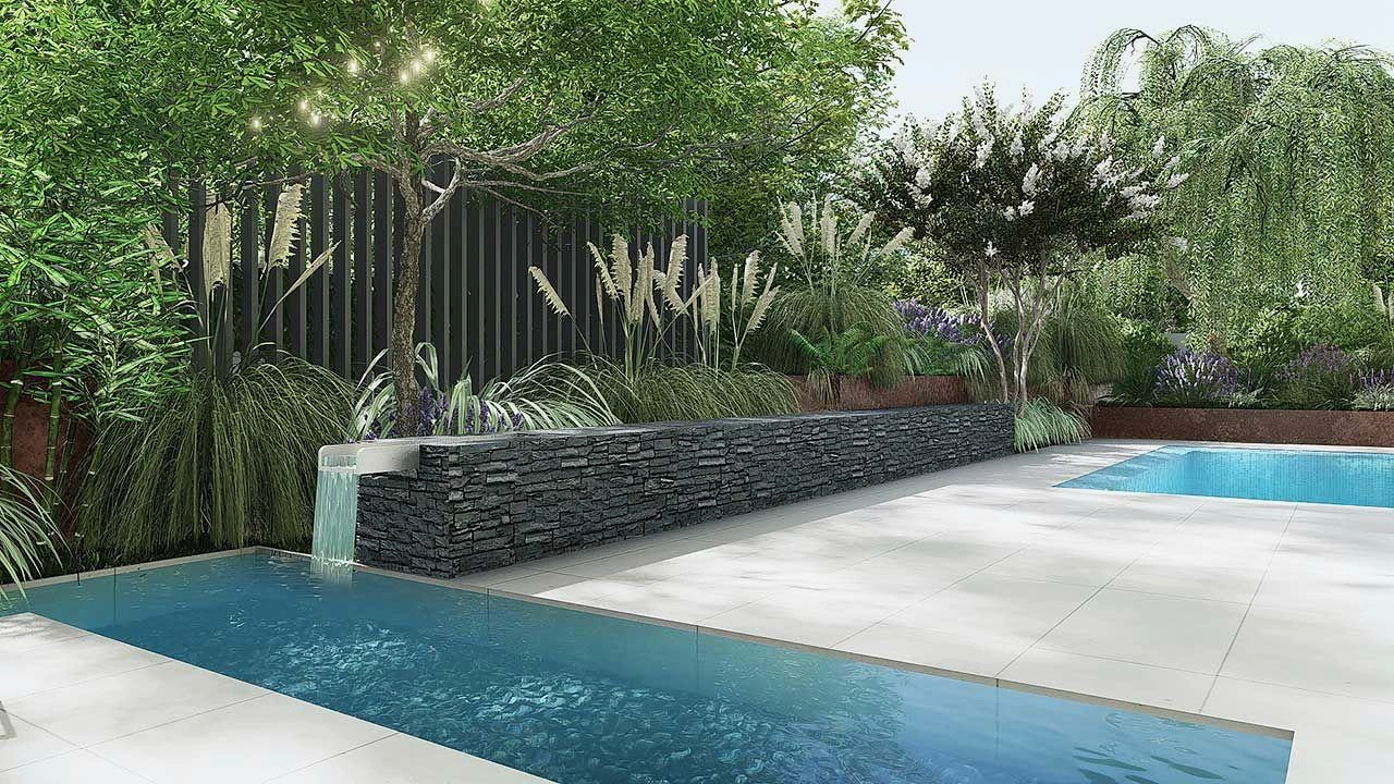 Garden waterfall set into a stone wall beside planted beds.