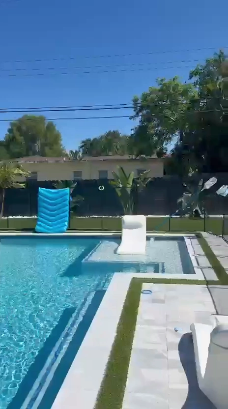 After: completed lawn and border planting around the existing pool.