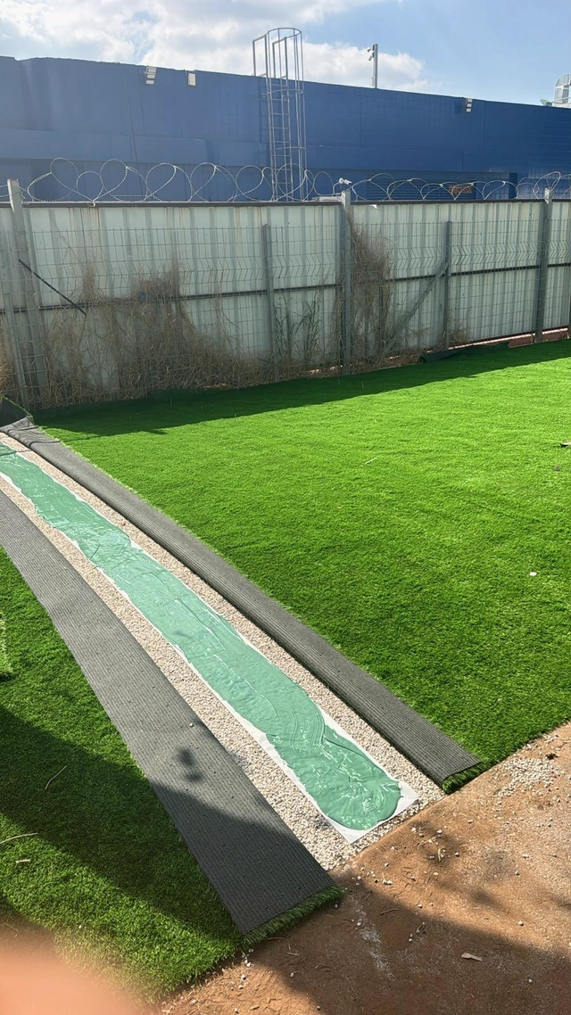 Artificial turf sections joined along a straight edge.